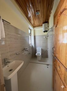a bathroom with a sink and a toilet at Tilanjali Stay in Soreng