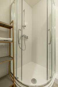 a shower with a glass door in a bathroom at The Wee Thistle in Edinburgh