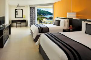 Postel nebo postele na pokoji v ubytování Dreams Huatulco Resort & Spa