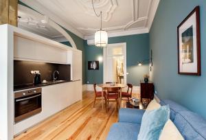 
a living room filled with furniture and a kitchen at Aparthotel Oporto Alves da Veiga in Porto
