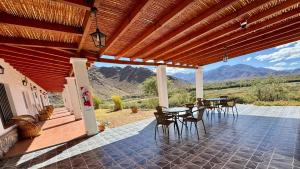 a patio with tables and chairs with mountains in the background at Luna Vallista Apart Hotel in Seclantás