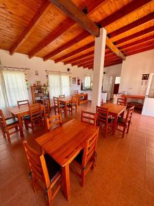 a dining room with wooden tables and chairs at Luna Vallista Apart Hotel in Seclantás +24 photos
