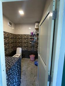 a small bathroom with a sink and a toilet at Ashirwad Homestay in Bhowāli