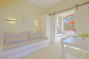 a white living room with a couch and a table at Villa Pami in Almiros Beach +102 photos