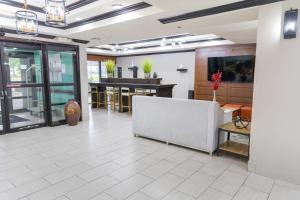a large room with a lobby with a table at Wingate by Wyndham North Little Rock in North Little Rock