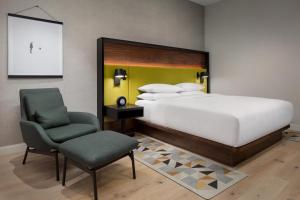 a bedroom with a large bed and a chair at Hyatt Centric Mountain View in Mountain View