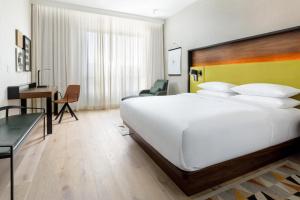 a bedroom with a large white bed and a desk at Hyatt Centric Mountain View in Mountain View