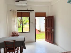 a dining room with a table and a door at Villa 64 - Airport Transit in Katunayaka
