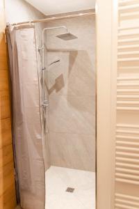 a shower with a glass door in a bathroom at Ferienwohnung Enzian in Halblech +21 photos
