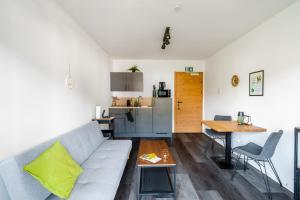 a living room with a couch and a table at Seeblick Homes in Fuschl am See