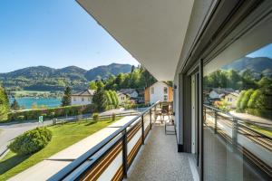 a balcony with a view of a lake and mountains at Seeblick Homes in Fuschl am See