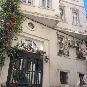 a white building with windows and flowers on it at The White Swan Suites Beyoglu in Istanbul
