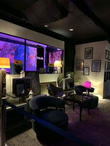 a living room with couches chairs and a tv at Hotel Bella Monte in Olongapo