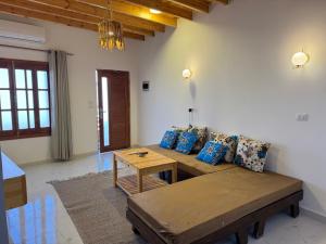 a living room with a couch and a table at Blue Villa in Lighthouse in Dahab