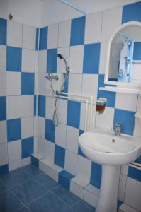 a blue and white bathroom with a sink and a shower at Camere de închiriat Doriana in Vama Veche +37 photos