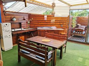 a kitchen with a wooden table and chairs in a room at The Deck in Jeffreys Bay