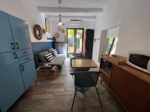 a living room with a couch and a table at Une pause vacances in Bandol +2 photos