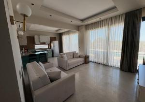 a living room with two couches and a kitchen at Olea Stone Houses in Bodrum City