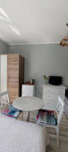a living room with a table and a dresser at Pokoje gościnne Małgorzata Dąbrowska in Kołobrzeg