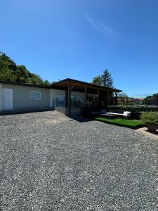 a house with a gravel driveway in front of it at Vikendica Mavi in Gradačac