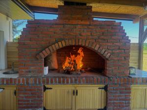 a brick oven with a fire in it at Vikendica Mavi in Gradačac +8 photos