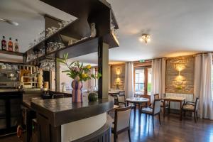 a kitchen and dining room with a bar and tables at La CHARMILLE PADIRAC in Padirac