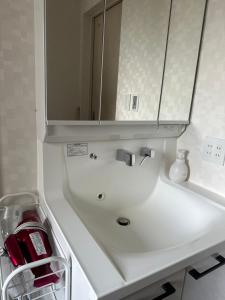 a bathroom sink with a mirror above it at any one in Chitose