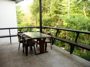 a patio with a table and chairs on a balcony at Plerntaan HoReCa in Ban Khlong Kum