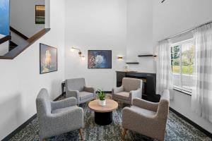 a waiting room with chairs and a table at Sleep Inn near Washington State Line in Post Falls