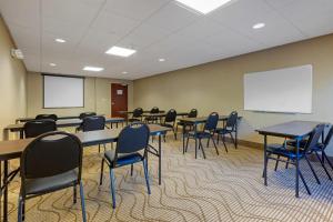 a conference room with tables and chairs and a whiteboard at Comfort Inn & Suites Cambridge in Cambridge +36 photos
