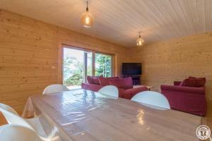 a room with a table and chairs and a couch at Le grand tétras in Boutx