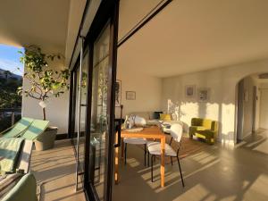 a room with a table and chairs on a balcony at Morcote Limone Suite mit traumhafter Seesicht in Morcote
