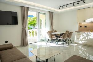 a living room with a couch and a table at Stevovic Apartments - Brand New Apartments in Tivat