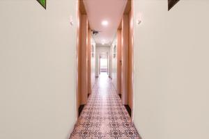 a hallway with a tile floor and a long corridor at Via 24x7 in Mumbai