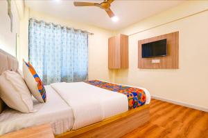 a bedroom with a bed and a flat screen tv at Via 24x7 in Mumbai