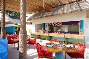 an outdoor dining area with red chairs and tables at Hyatt Regency Koh Samui in Chaweng