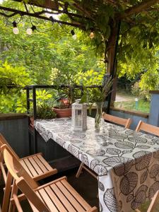 a table with a vase and chairs on a patio at The Bookhouse Home Bb in Poggio San Marcello 