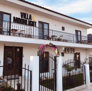 a white building with a wrought iron fence at Casa Moonlight 2 Mai in 2 Mai