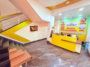 a fast food restaurant with a yellow counter at Hotel Kings Residency Panvel in Navi Mumbai
