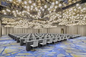 an empty hall with rows of chairs and chandeliers at Hyatt Regency Shanghai Pudong Lingang in Zhenghai +112 photos