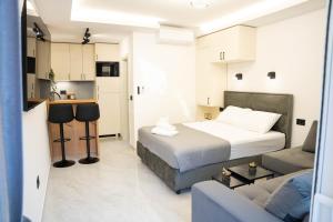 a bedroom with a bed and a living room with a couch at Stevovic Apartments - Brand New Apartments in Tivat