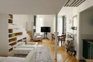 a living room with a couch and a table at Peaceful haven in Honfleur