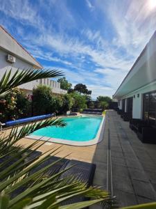 a swimming pool on the side of a building at Casa de la Mare in Eforie Sud