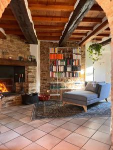 a living room with a couch and a fireplace at The Bookhouse Home Bb in Poggio San Marcello 