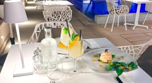 a white table with a plate of food and wine glasses at Villa Massa Residence in Sant'Agnello