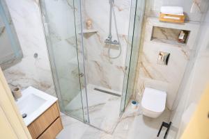 a bathroom with a shower and a toilet and a sink at Stevovic Apartments - Brand New Apartments in Tivat +68 photos
