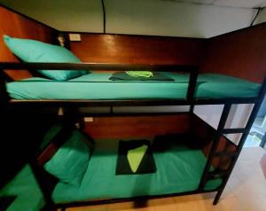 a bunk bed with a green bunk bed at Czone Hostel in Ko Tao