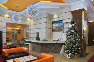 a christmas tree in the lobby of a hospital at Grand Voyage Hotel in Almaty