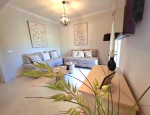 a living room with a couch and a table at Villa Tina Country Beach Apartments in Acharavi