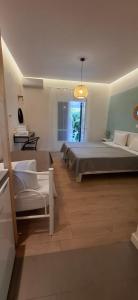 a large bedroom with two beds and a chandelier at Amelia's Garden in Kavos +94 photos